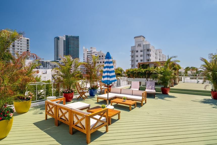 A rooftop patio with outdoor furniture and city view